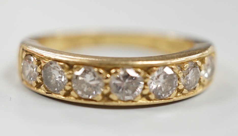 A modern 18ct gold and seven stone diamond set half hoop ring, size P, gross weight 5.3 grams.